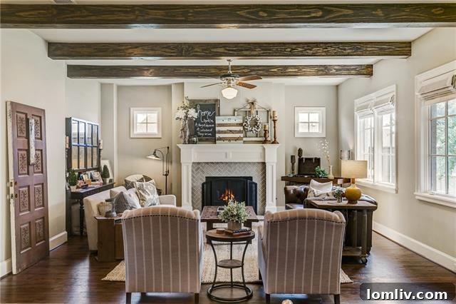 Spacious open-concept living area overlooking the kitchen and dining room, featuring exposed architectural beams