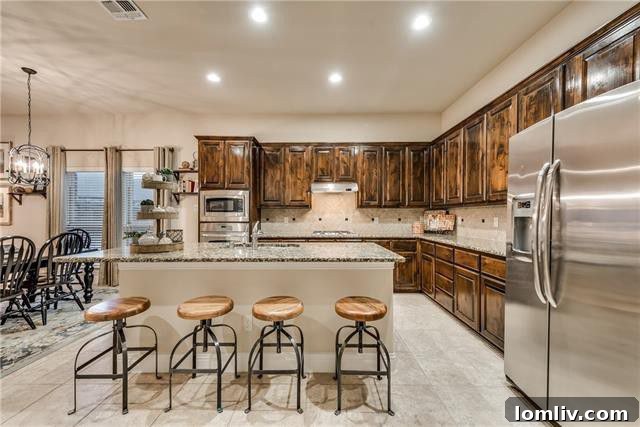 Gourmet kitchen with elongated island and Knotty Alder cabinets