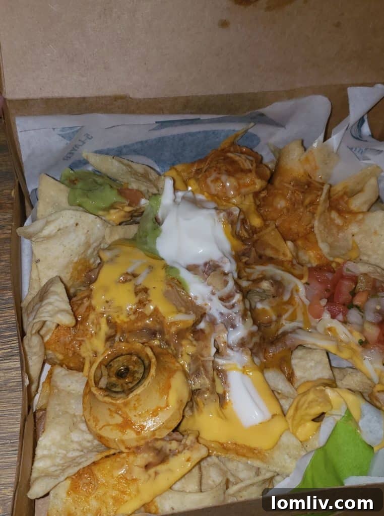 Close-up of nachos with a doorknob-like object, from Eve Saint's Facebook post