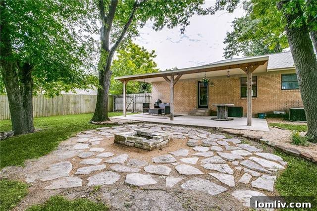 Custom-built stone firepit in the large, heavily treed backyard of the McKinney home, ideal for social gatherings and relaxation