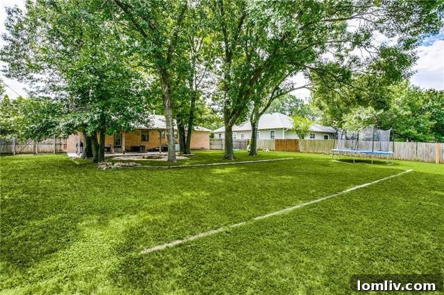 Lush, private backyard in McKinney with mature trees, offering a serene and expansive escape, showcasing the property's natural beauty