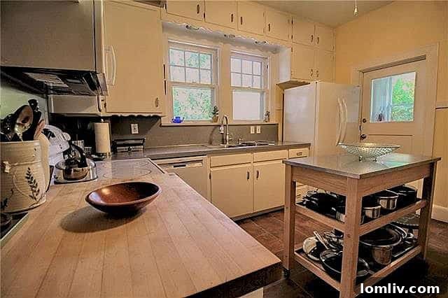 The kitchen area, offering renovation potential while retaining vintage charm.