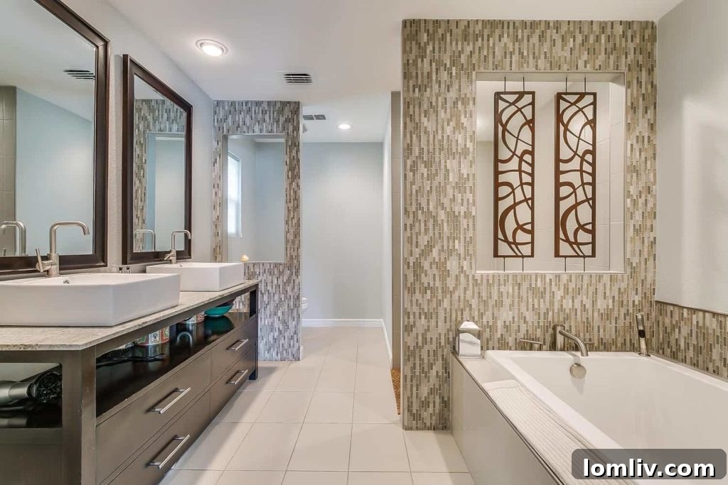 Midcentury Chic in Ridglea Hills Designed for Dazzling Gatherings 9 The elegant master bathroom of Master Suite No. 1, designed for luxury and comfort.