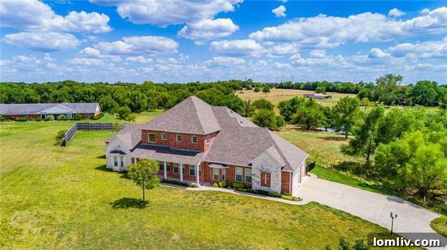 Wallace Lane Rockwall luxury home exterior with lush landscaping and pond
