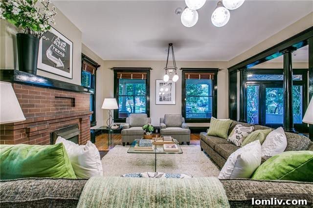 Dining area illuminated by natural light from a wall of windows in 3403 Knight Street