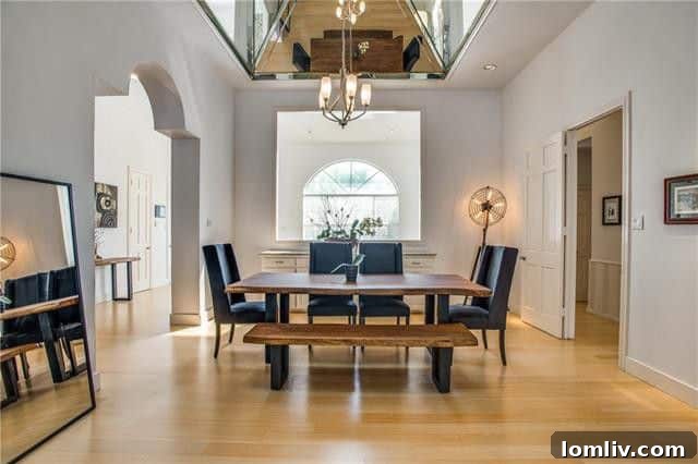 Spacious Oak Cliff Contemporary: Built for Bliss, Designed for Downtime 5 The sophisticated formal dining room at 731 Kessler Lake Drive, featuring a distinctive mirrored ceiling that enhances its luxurious atmosphere.