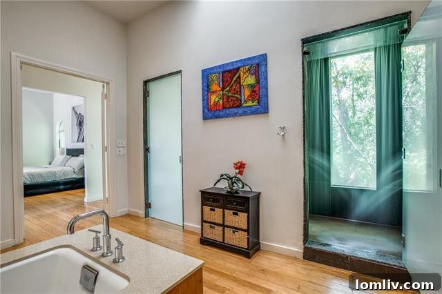 Spacious Oak Cliff Contemporary: Built for Bliss, Designed for Downtime 9 The serene soaking tub and a glimpse of the private hot stone sauna within the opulent master bathroom suite at 731 Kessler Lake Drive.