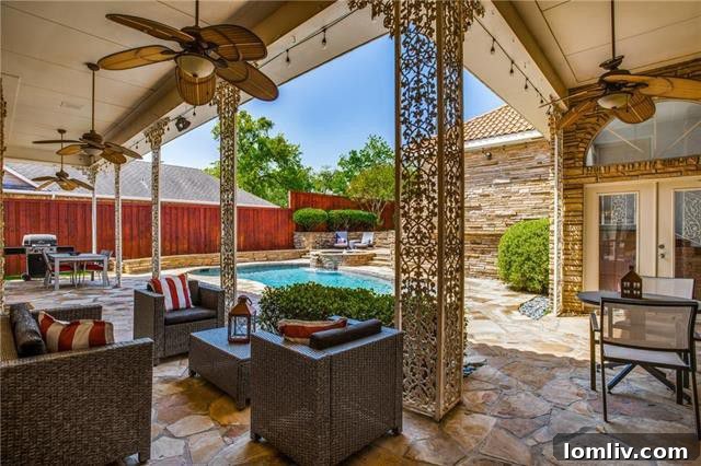 Spacious Oak Cliff Contemporary: Built for Bliss, Designed for Downtime 10 The beautiful outdoor swimming pool and attached spa, surrounded by an expansive stone patio, perfect for year-round enjoyment at 731 Kessler Lake Drive.