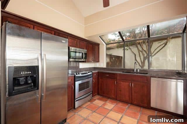 Eat-in kitchen with granite countertops and modern appliances
