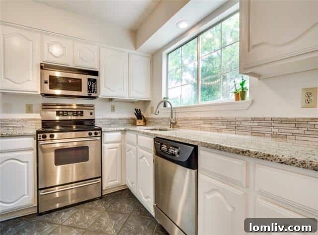 Modern kitchen with stainless steel appliances and granite countertops