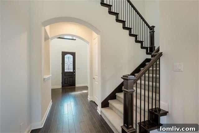 Grand entrance and stone facade of the newly built First Texas Home at 1755 Prescott Pass Place, Farmers Branch.