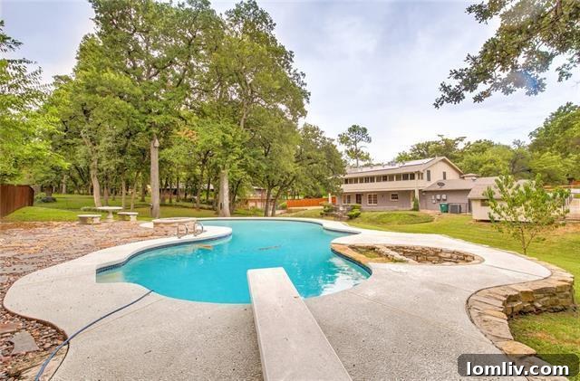 Close-up of the inviting, organically shaped swimming pool in the private backyard oasis