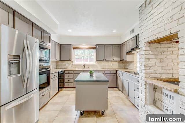 Kitchen view showing extensive cabinetry and a glimpse of the dining area at 5909 Monterrey Lane