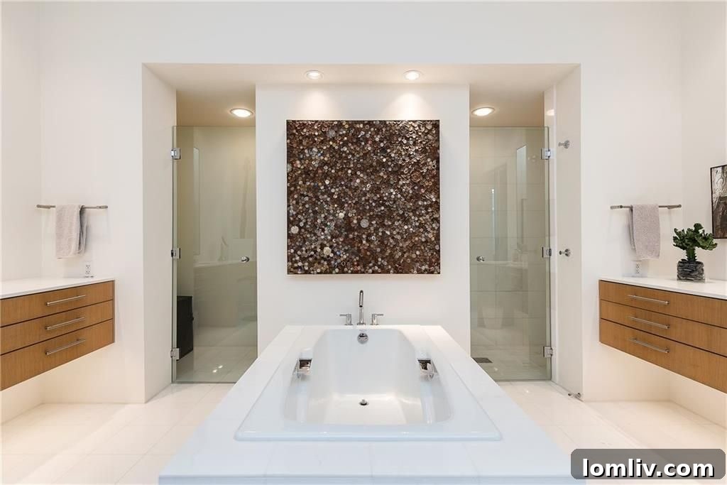 Spa-like master bathroom with luxurious soaking tub, spacious walk-in shower, and dual vanities