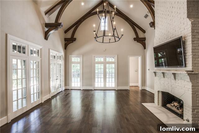 Elegant living room with high ceilings and fireplace in luxury Preston Hollow home