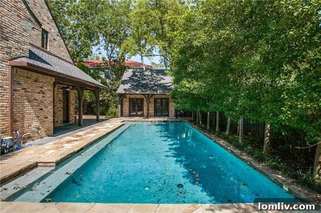Outdoor swimming pool and private cabana in luxury Preston Hollow backyard