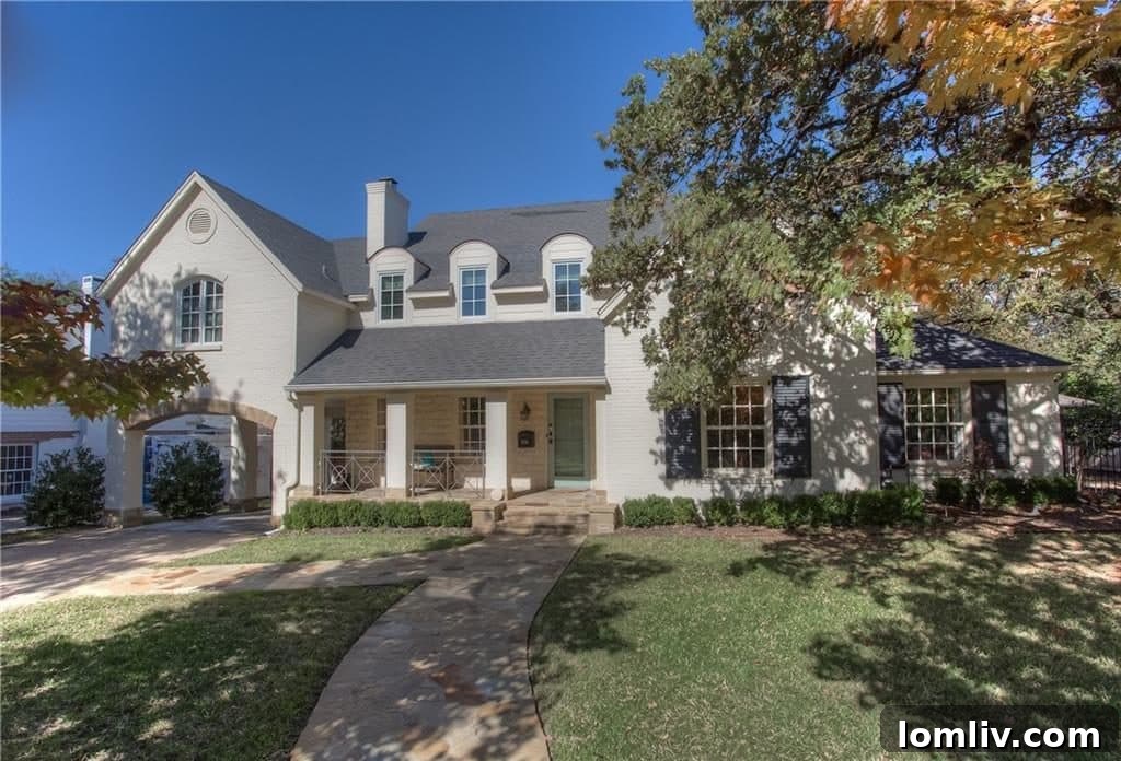The grand facade of 3720 Cresthaven Terrace, an English Tudor-inspired masterpiece.