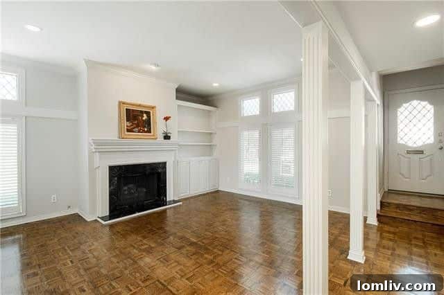 Turnkey Living: A Preston Forest Bargain Steps to Whole Foods 3 Interior view showcasing the grand living area with fireplace, built-in shelves, and rich parquet floors in a Preston Forest condo