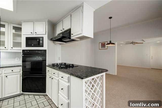 Turnkey Living: A Preston Forest Bargain Steps to Whole Foods 5 Spacious kitchen with crisp white cabinetry, black granite counters, and high-end double oven in a Preston Forest condo