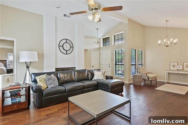Inviting living area with high vaulted ceilings and light wood floors at 421 Dillard Lane