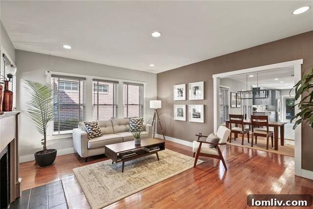 Cozy living room featuring a warm fireplace and abundant natural light, creating a welcoming ambiance.
