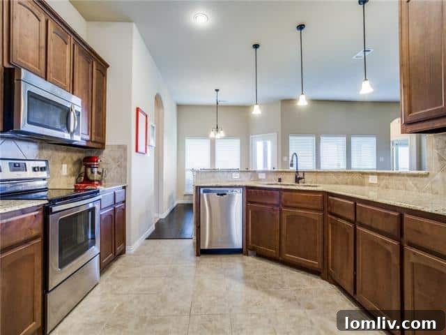 Modern kitchen with wood cabinets and granite countertops at 19201 County Road 646