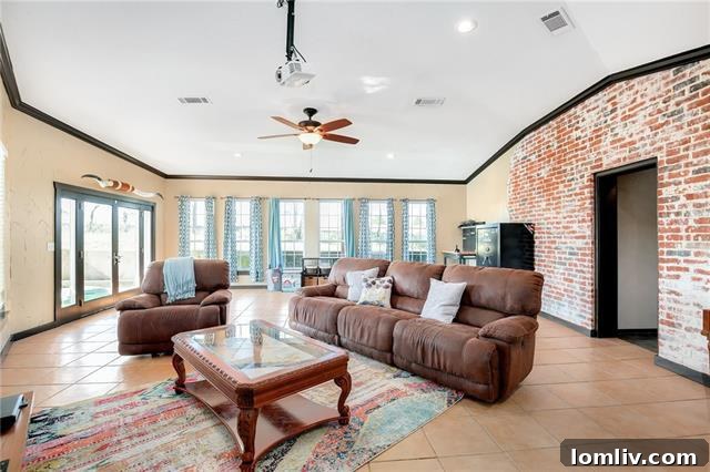 Spacious open living area with exposed brick at 2409 County Road 645