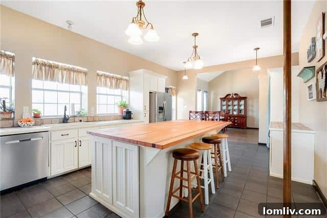 Modern chef's kitchen with butcher block island at 2409 County Road 645