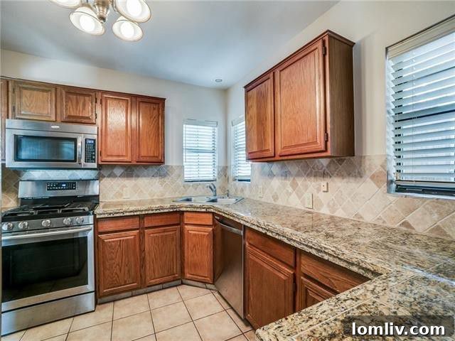 Modern kitchen with marble countertops, stainless steel appliances, and sleek cabinetry