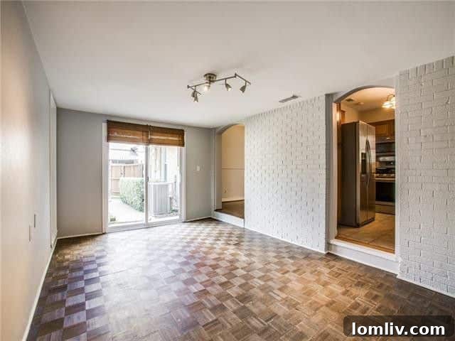 Spacious and bright bedroom featuring a bay window and refurbished hardwood floors