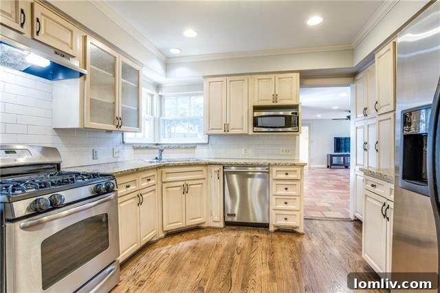 Modern, updated kitchen with stainless steel appliances and stylish finishes in a Lower Greenville home