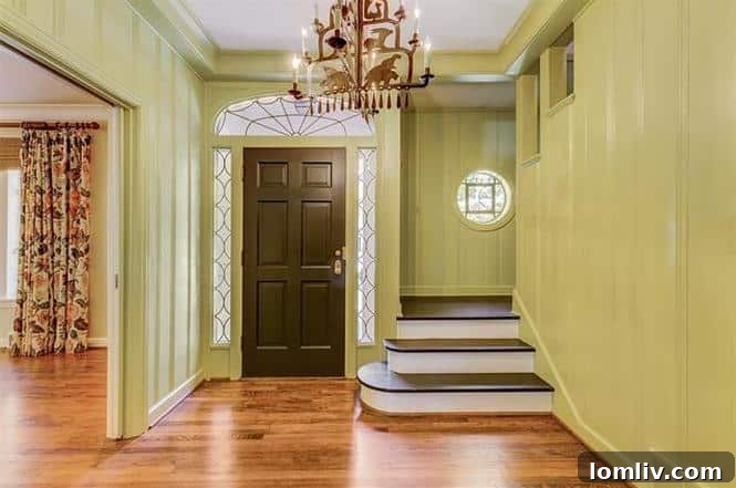 Elegant Entryway with Black Door and Quarter Turn Staircase