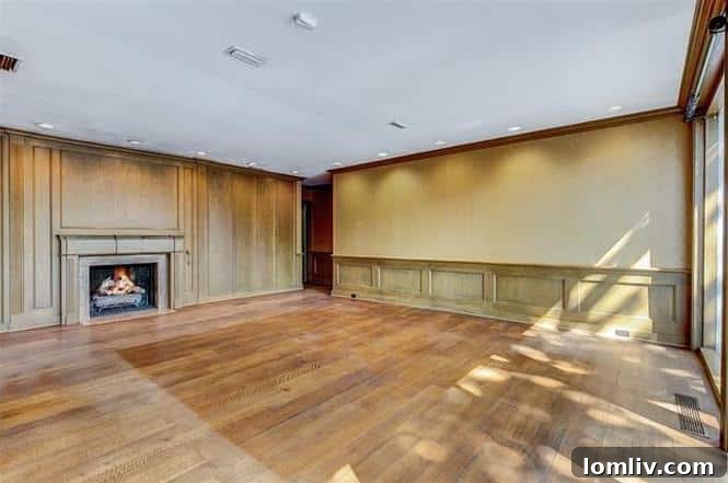 Warm Family Room with Fireplace, Paneling, and Bookcases