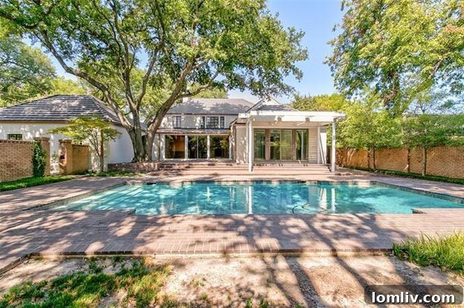 Stunning Backyard with Swimming Pool, Brick Hardscape, and Lush Landscaping