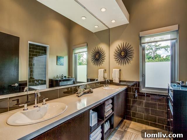 Designer master bathroom featuring dual vanities and sleek modern fixtures