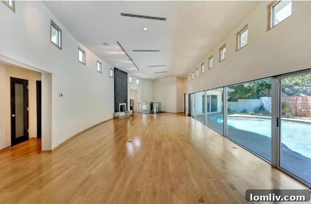 Original living room at 304 Crestwood Drive, showcasing its dated interior design elements.