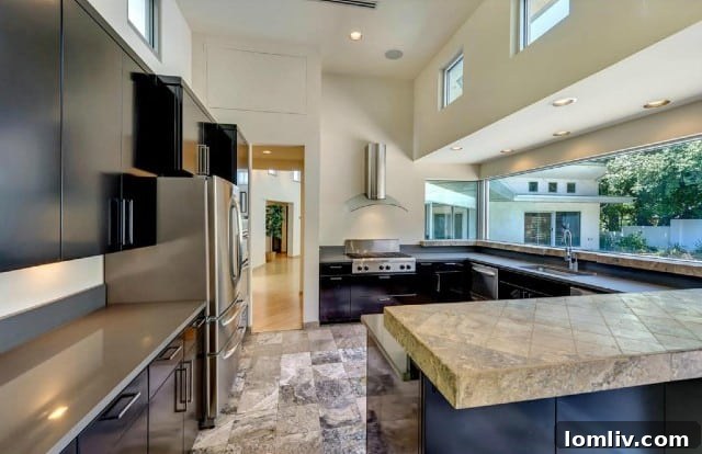 The original kitchen at 304 Crestwood Drive, showcasing its outdated design and enclosed feel.