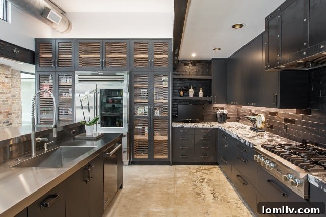 Newly renovated kitchen at 304 Crestwood Drive, featuring a blend of metal, stainless steel, and soapstone, with exposed air ducts as an industrial design element.