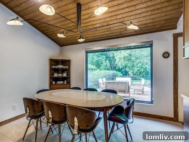 Killer Light Fixture and Treed Backyard View in Dining Area