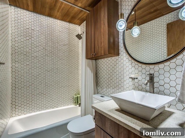 Chic Guest Bathroom with Hexagonal Tile Wall and Designer Fixtures