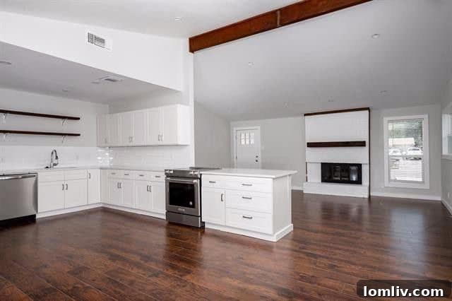 Open concept kitchen with white cabinetry, open shelving, and modern appliances at 2962 Satsuma Drive.
