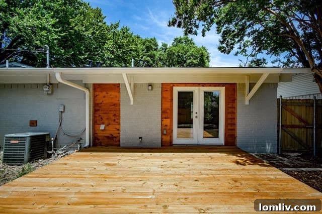 Backyard featuring a new deck and board-on-board fence, with matching wood trim accents at 2962 Satsuma Drive.