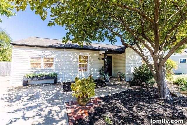 Charming Plano Bungalow Exterior with Lush Landscaping