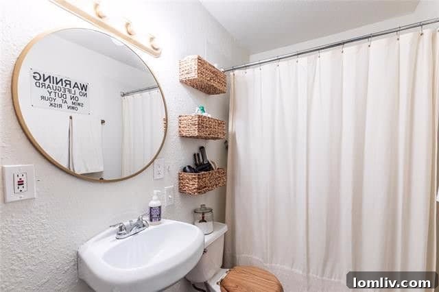 Minimalist Bathroom with White Walls and Wood-Topped Toilet Seat