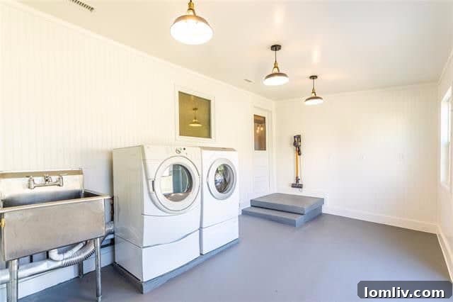 Spacious Utility Room with Industrial Lighting and Stainless Steel Sink
