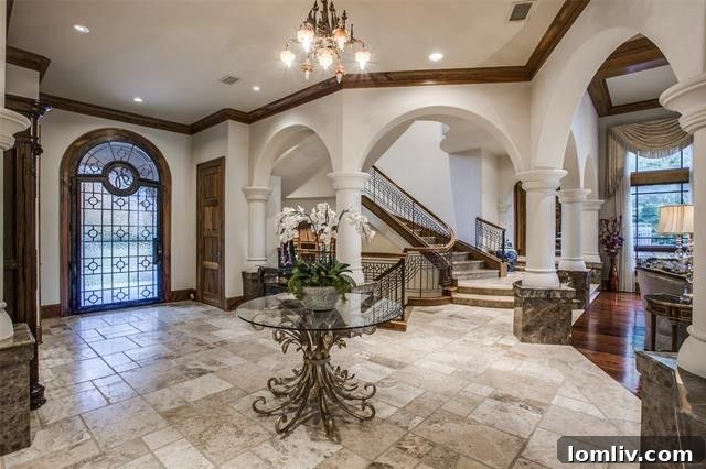 Grand foyer of Coram Deo with dramatic staircase and archways showcasing intricate details