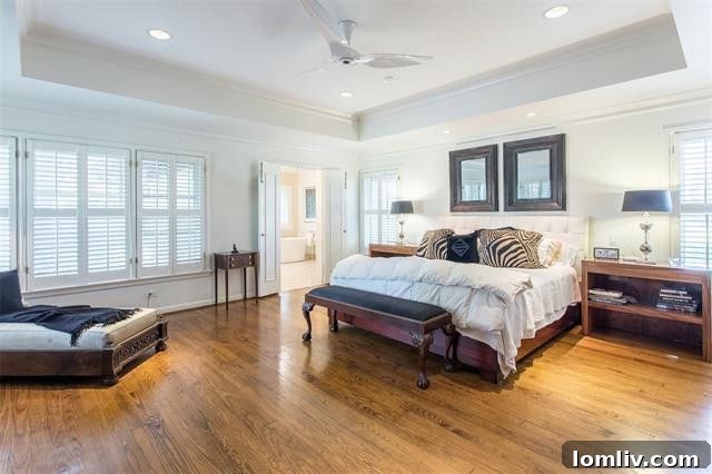 The inviting family room with a cozy fireplace and large Pella sliding glass doors opening to the outdoor areas, creating a bright and airy atmosphere.