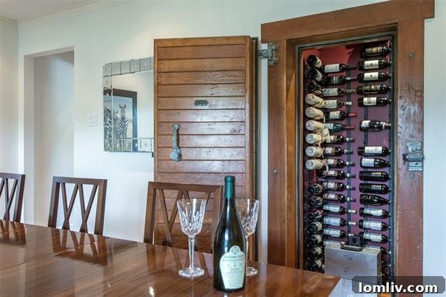 The rustic, antique Jamison freezer door repurposed as a unique entrance to the wine rack within the Inwood Road home.