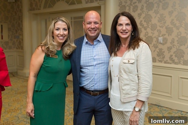 CEO Chris Kelly engaging with Emily Bock Bogda and Kelly Thompson at a Companywide Honor Roll event, celebrating team achievements.