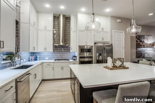 High-end white kitchen with quartz counters and large island